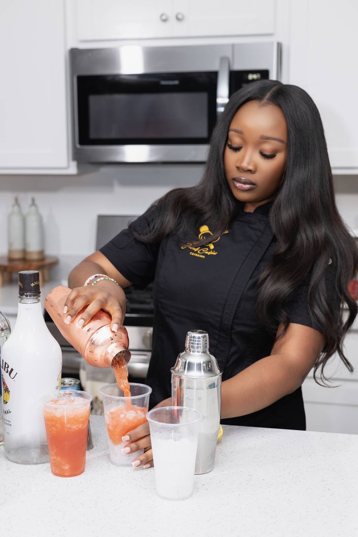 Jewel pouring a handcrafted cocktail from a copper shaker